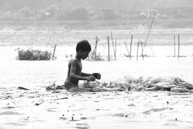 the child is playing in the water near the shore