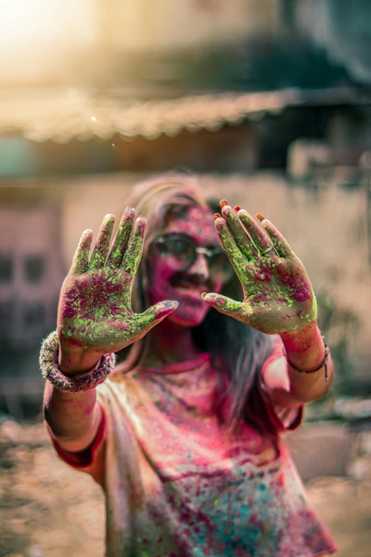 a woman with painted hands doing a gesture with both hands