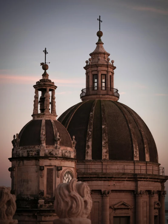 three spires on a church near a body of water