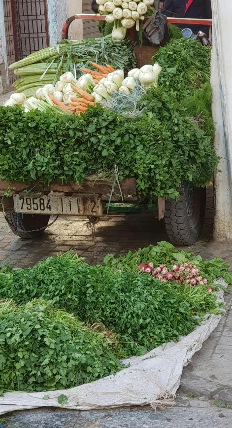 the man is selling produce on the back of the truck