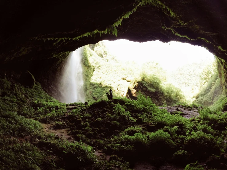 a waterfall from the inside of a cave