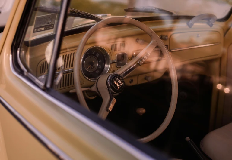 the interior of an older car with a steering wheel