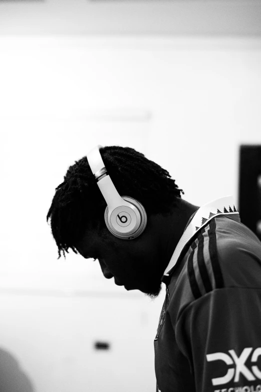 young man wearing headphones looking at his computer