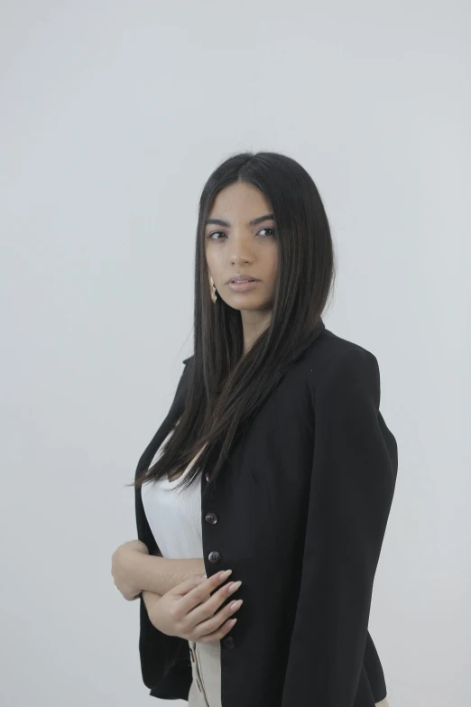 a woman in a black jacket and a white dress