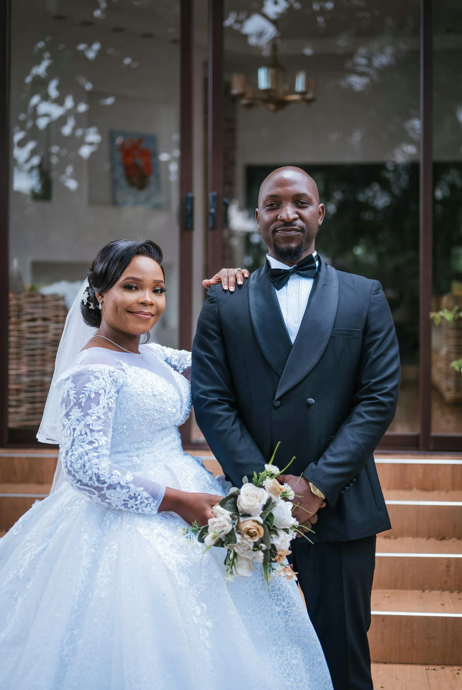 a bride and groom standing on stairs at their wedding