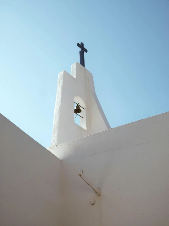 the bell tower of a church is pictured with a statue in the window