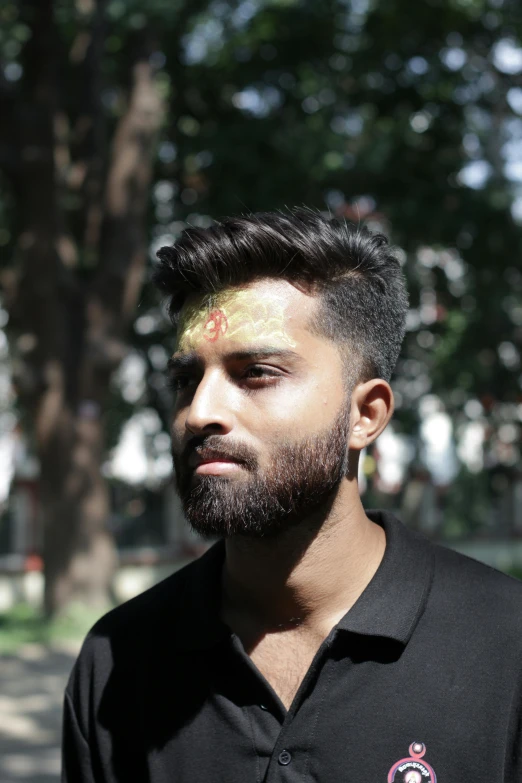 a man with a yellow face painted on his head