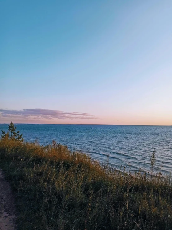 a bench by the shore and the sun