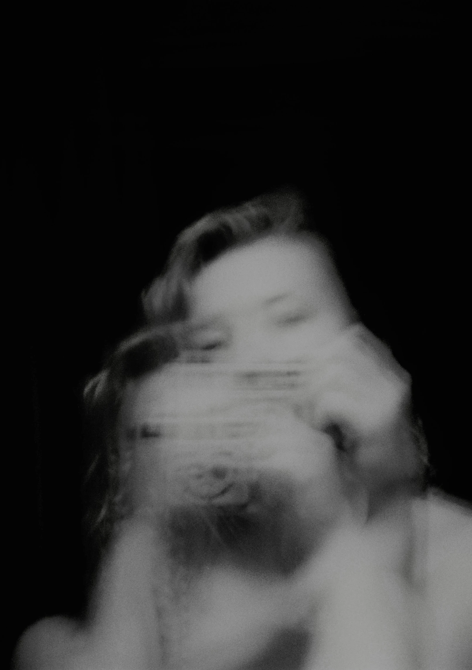 a blurry black and white po of a woman's face