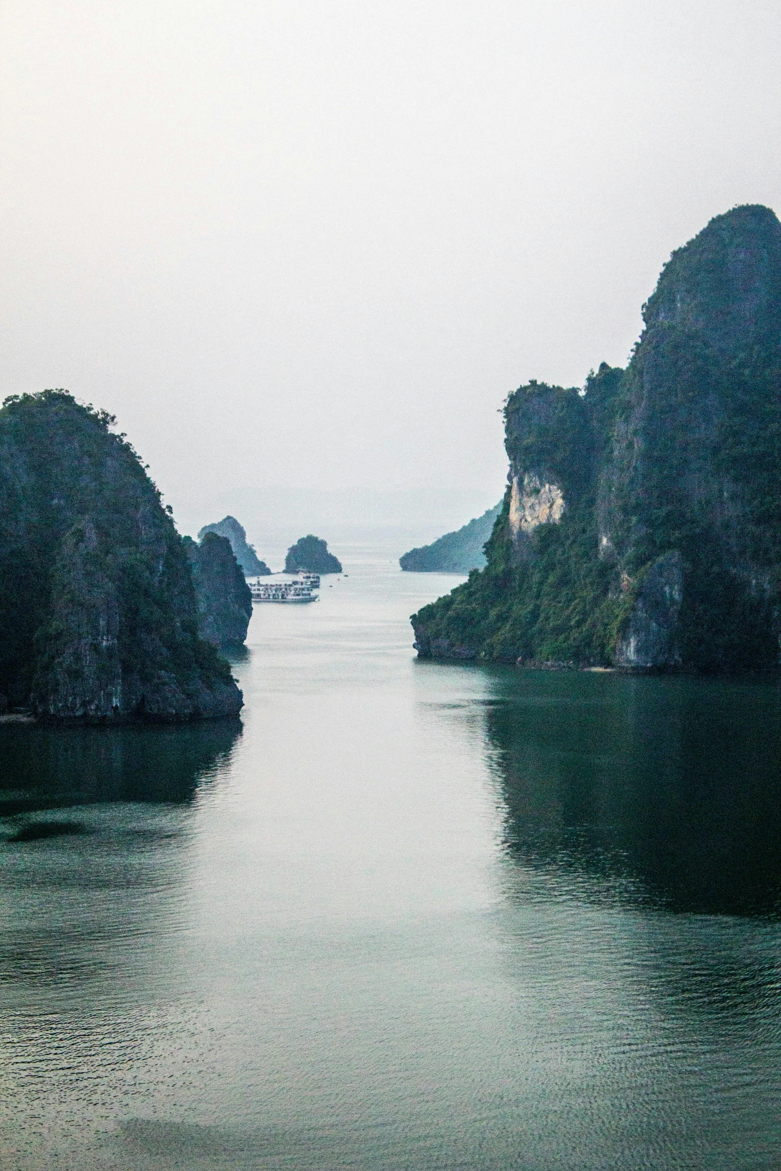 water is calm and hazy in the middle of a lake