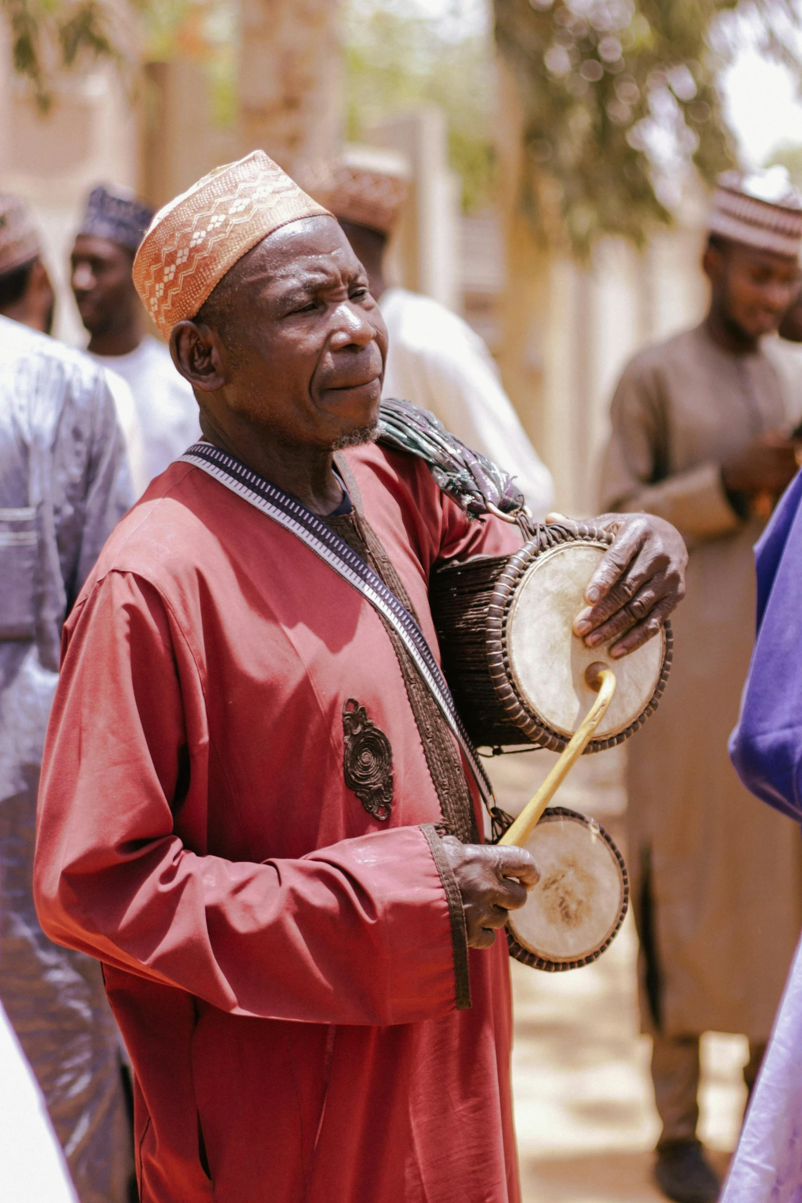 a man in red standing with some other men