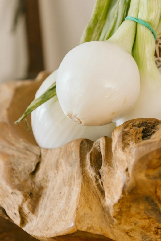 a picture of an onion next to another onion on a  board