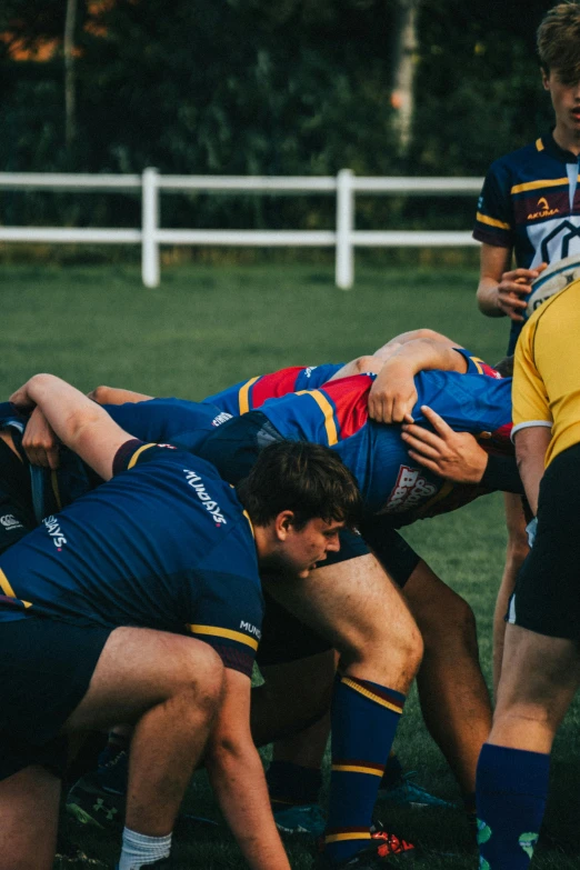 a group of players in a hurluck during a rugby match