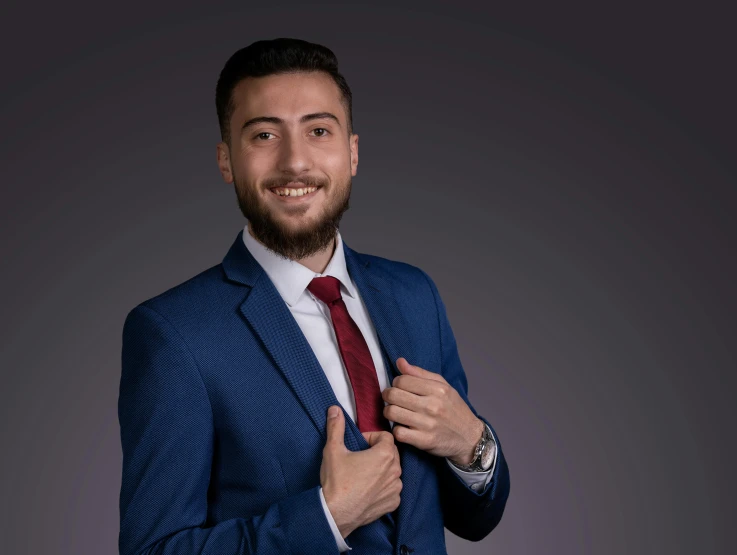 a man in a suit is wearing a red tie