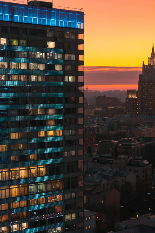 a very tall building with lots of windows in a city