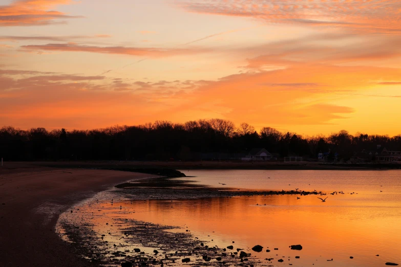 a red and yellow sunset on the beach