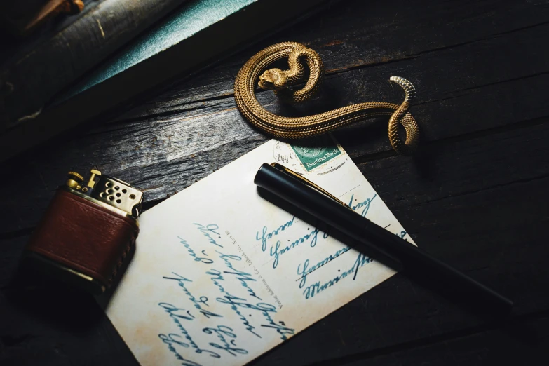 some letters and a pen sit on a wooden table