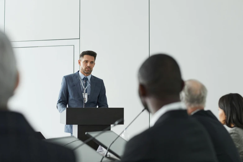 a man is standing at the front of an audience