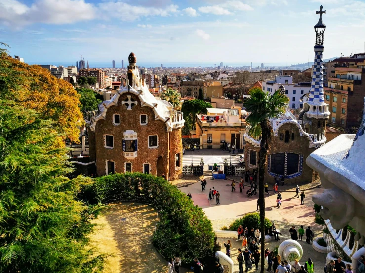 people in the plaza near several domes in barcelona