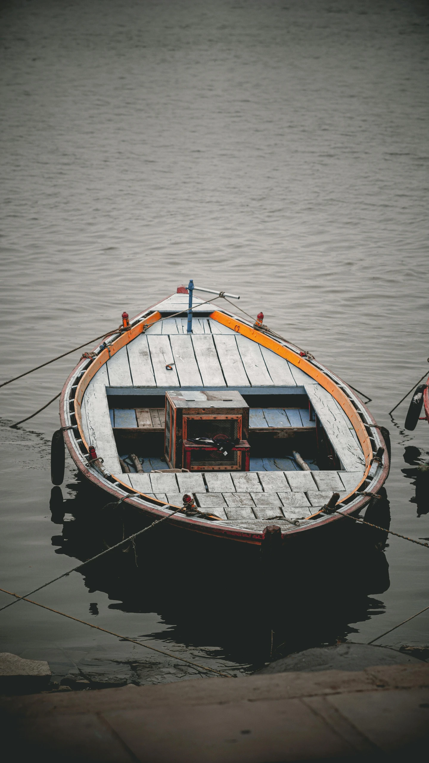 a boat sitting alone in the middle of some water