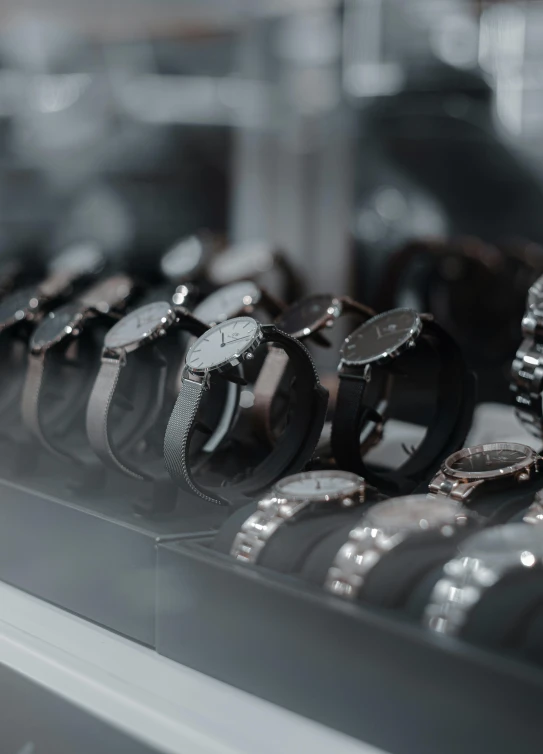 a group of watches sitting on a display shelf