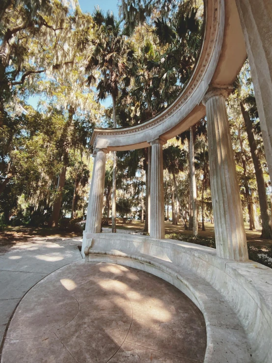 the circular stone bench has columns at the bottom