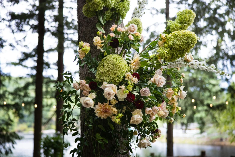 the floral arrangement is set on top of a tree in a park