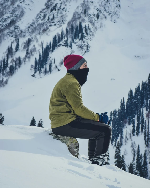 man on snowboard, with mountain in background