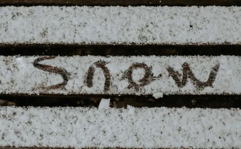 some snow is writing down on some benches