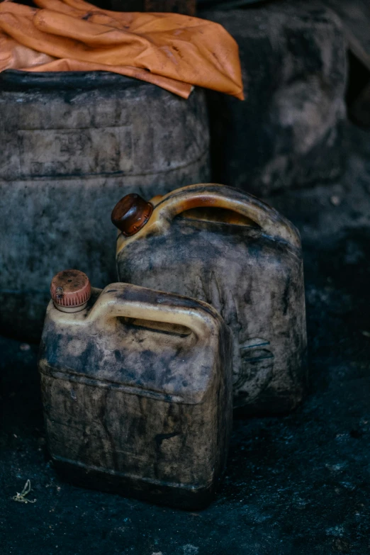 various old, dirty jugs sitting next to each other