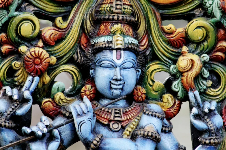 a very colorful and ornate statue is standing