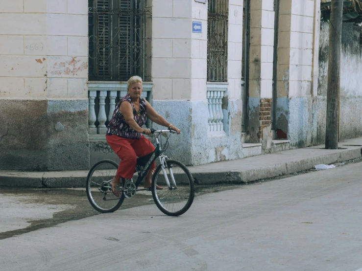 a person riding a bicycle on a narrow street