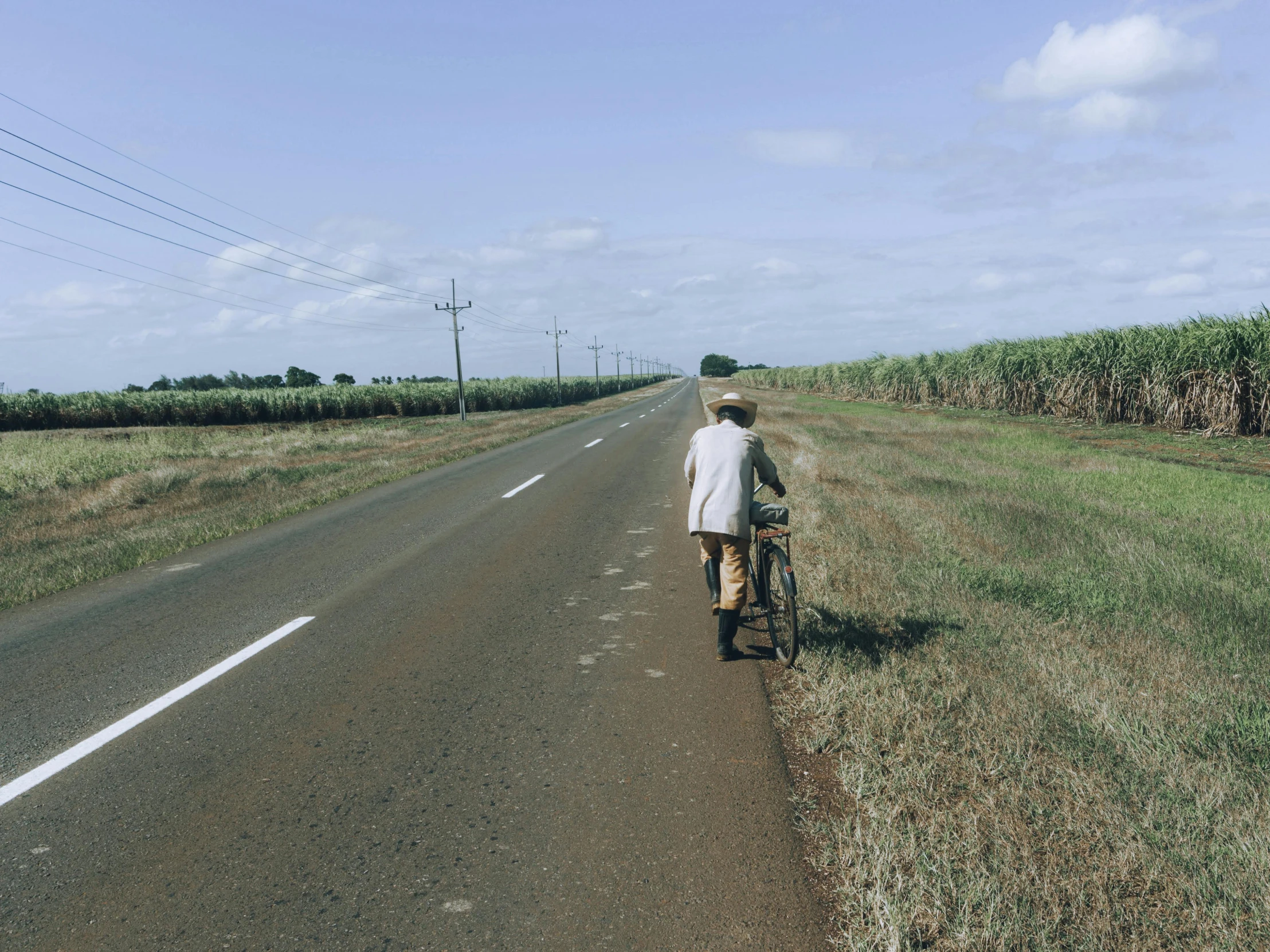 a man is riding his bike down the road