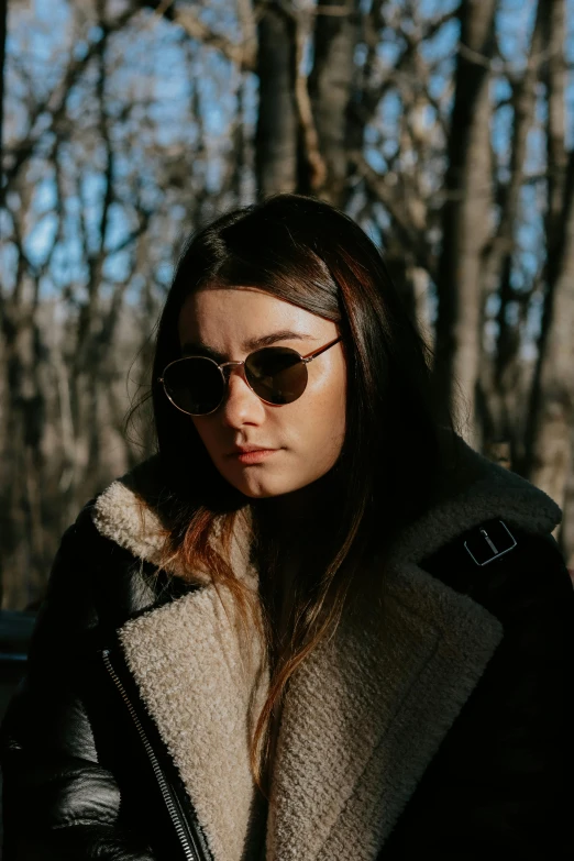 a woman with sunglasses and a jacket