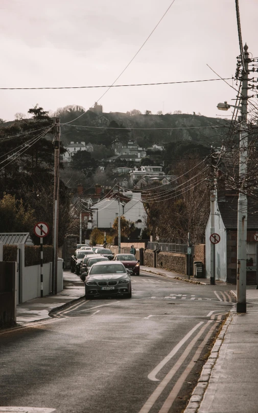 a few cars driving on a very empty road