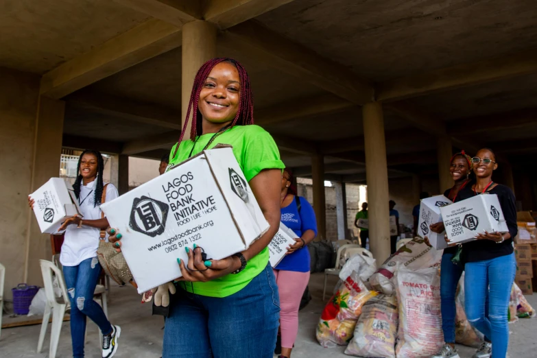 some women carrying boxes in their hands