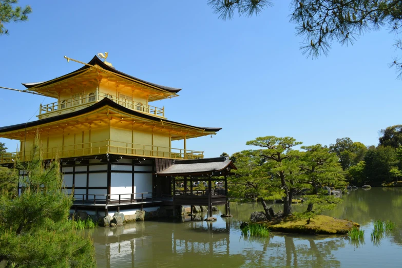 a view of a water pond and yellow building with two levels