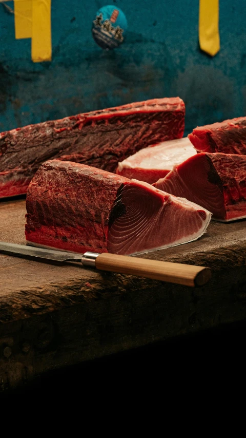 several cuts of beef are on a chopping board