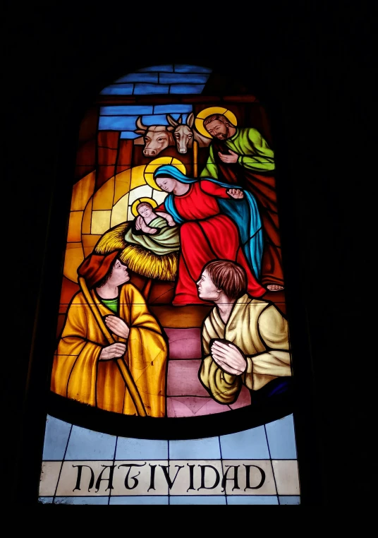 a stained glass window showing jesus, mary and john