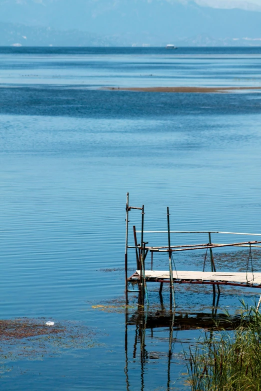 a dock extends into the blue sea