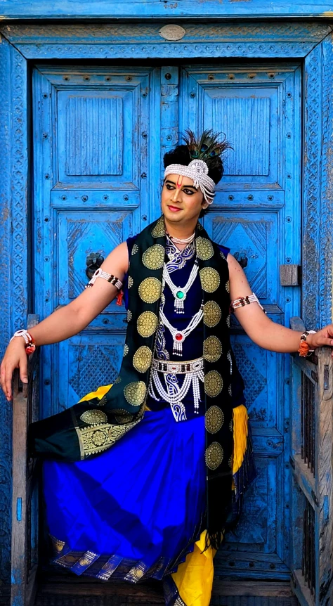 an old woman wearing a fancy blue and gold outfit