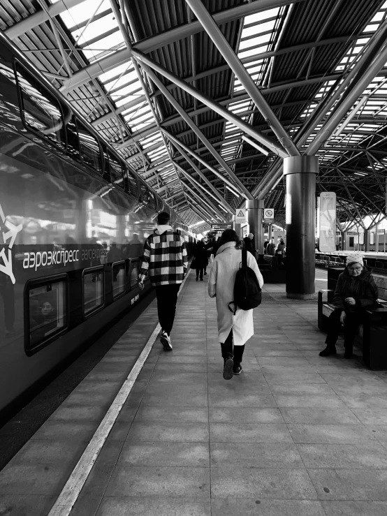 several people walk near the subway platform