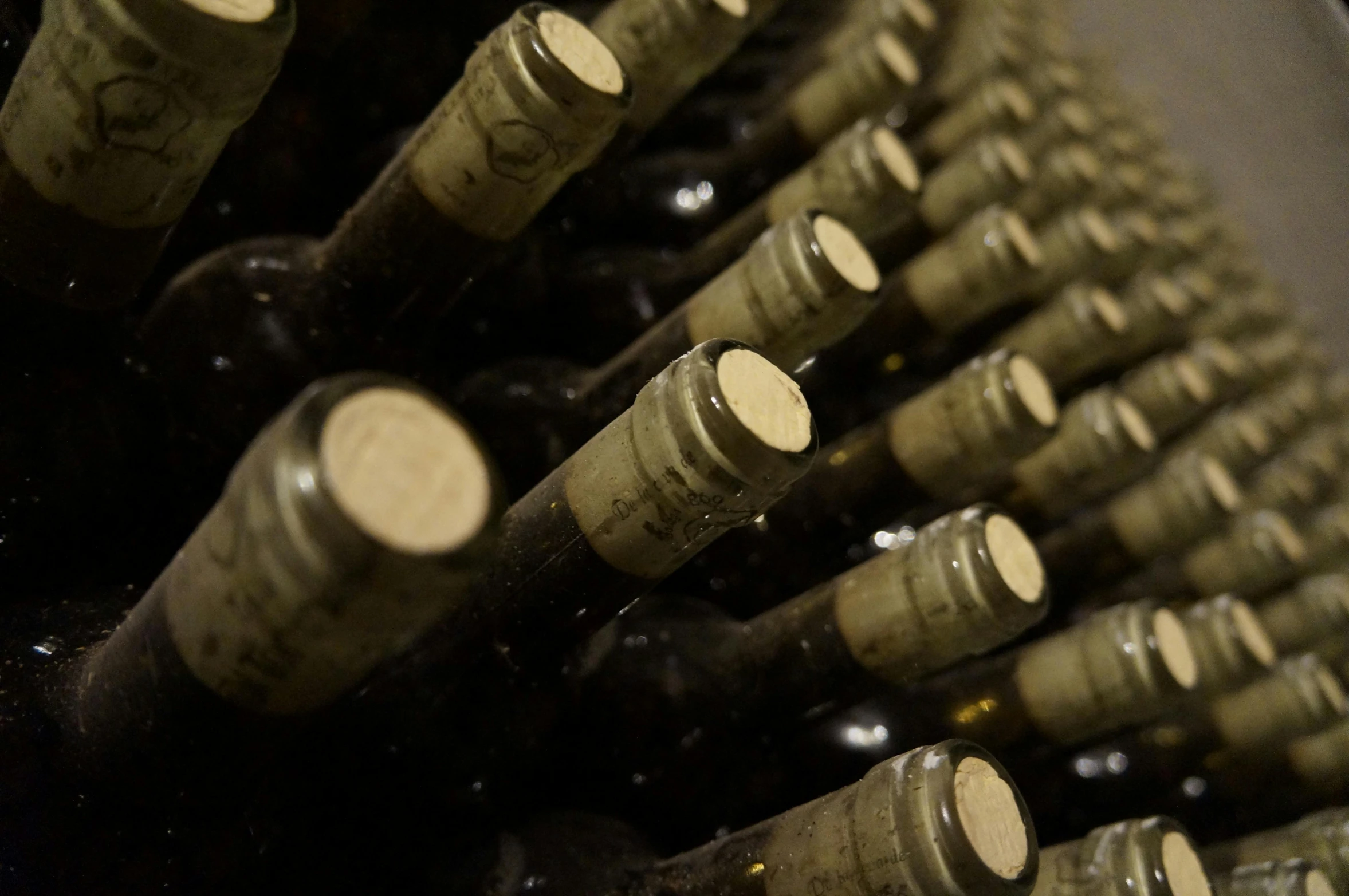 an image of a very close up picture of wine bottles