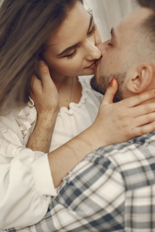 an affectionate couple cuddling for a kiss