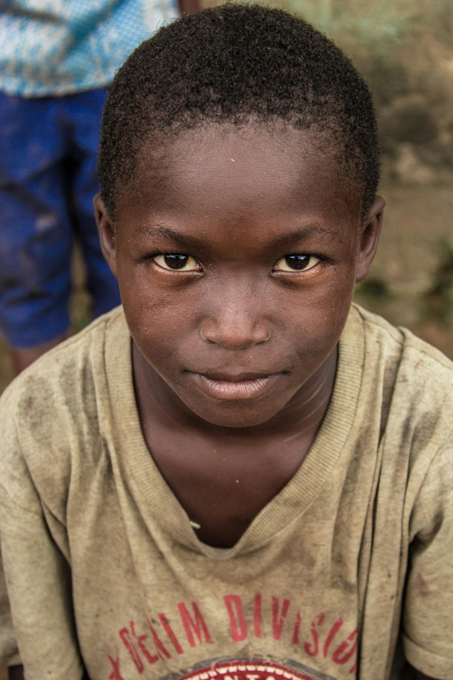  with dark eyes standing with other children