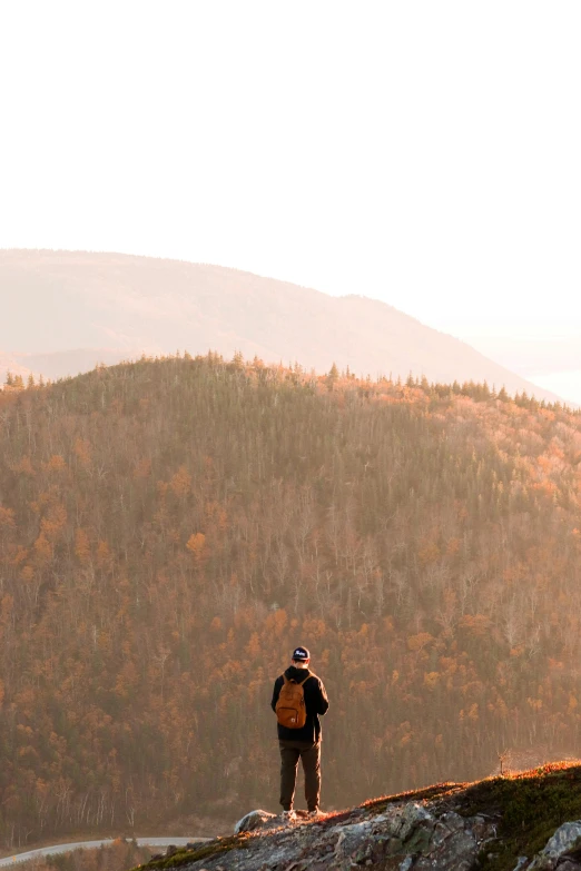 there is a man standing on the mountain top