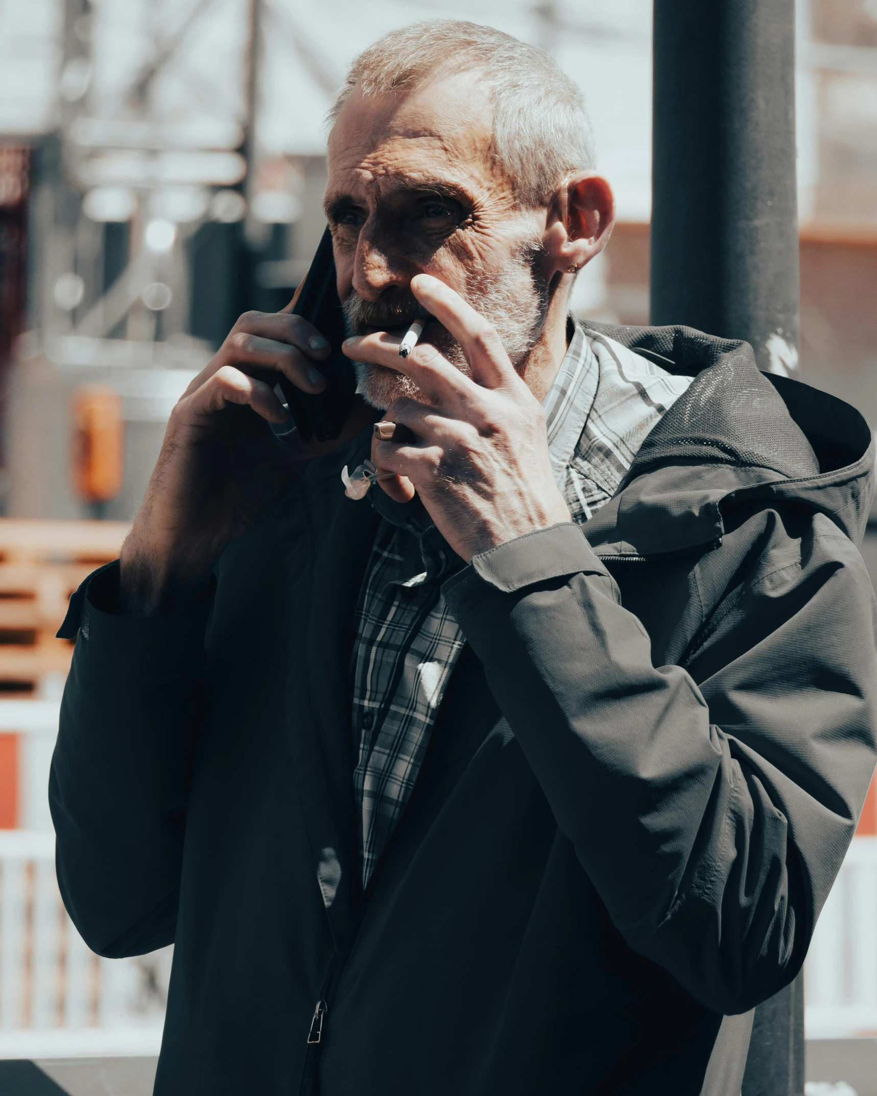man smokes and talks on the phone
