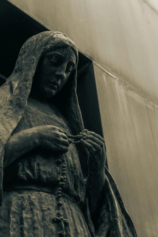 statue of mary wearing bonnet outside a building