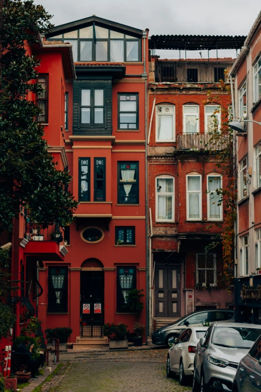 a red building with several windows on the top floor