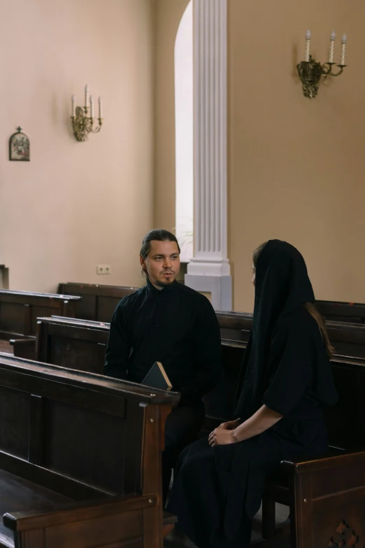 a man and a woman sitting in church pews